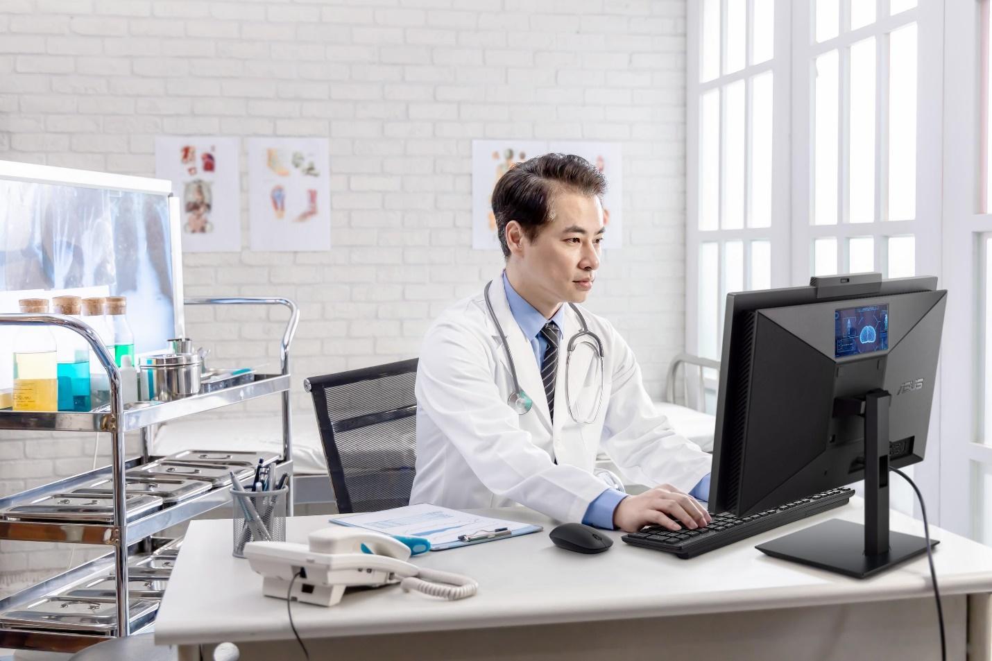 A doctor working on a computer
Description automatically generated with low confidence